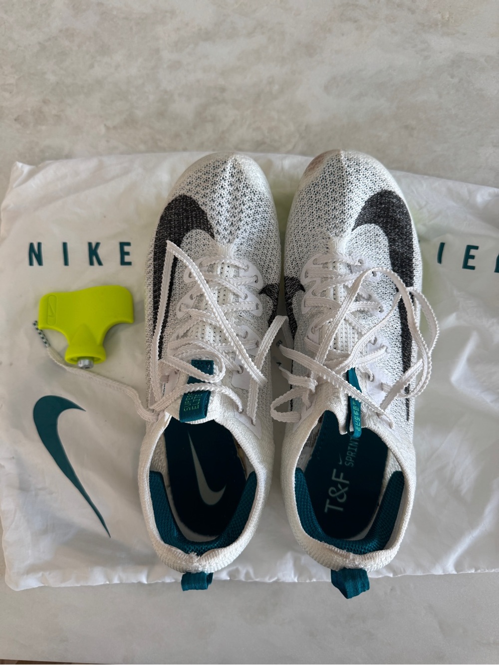 Nike White and Teal Flyknit Running Track Shoes with Black Swoosh spikes